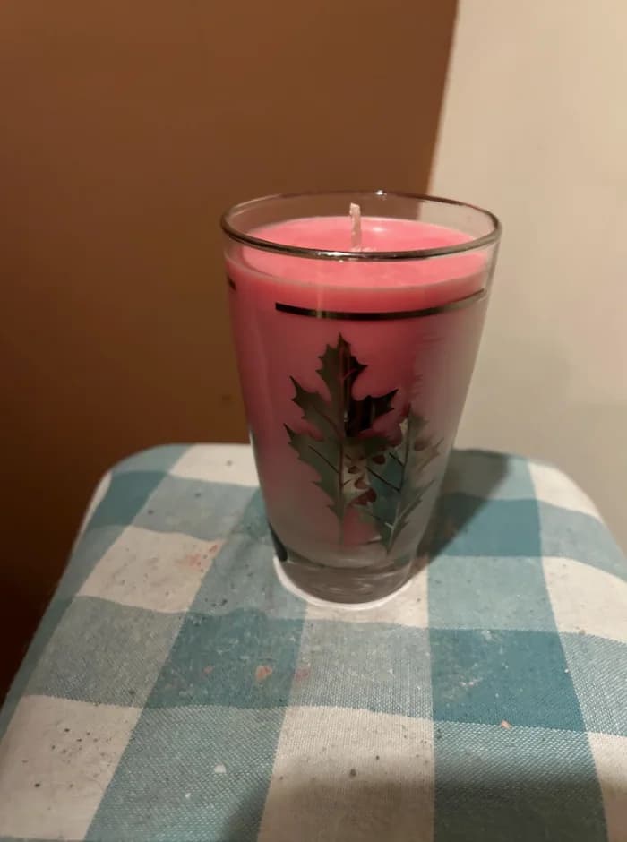 Original pink candle listing photo on a stained checkered surface